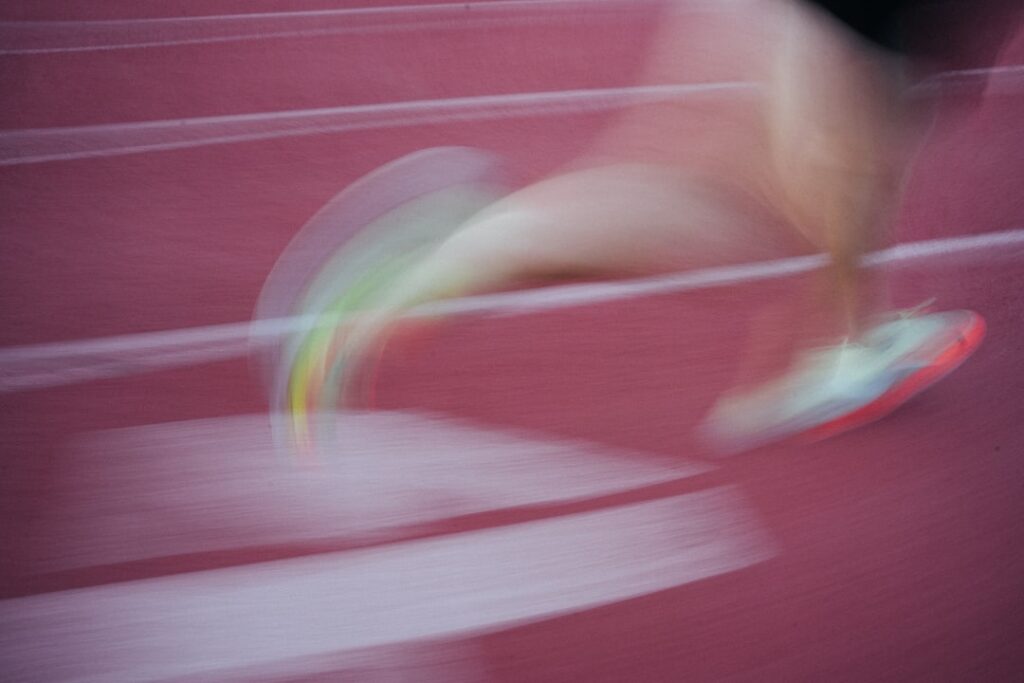 陸上トラックを走るランナーの足元